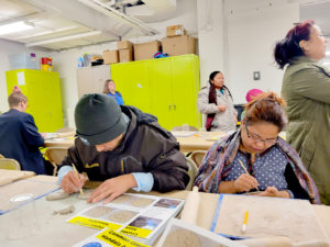 Deaf refugees from ‘Deaf New American Advocacy Inc.’ create clay mandala’s inspired by Neil Tetkowski’s sculpture the ‘World Mandala’ which consists of combining clay from 188 member countries of the UN together.