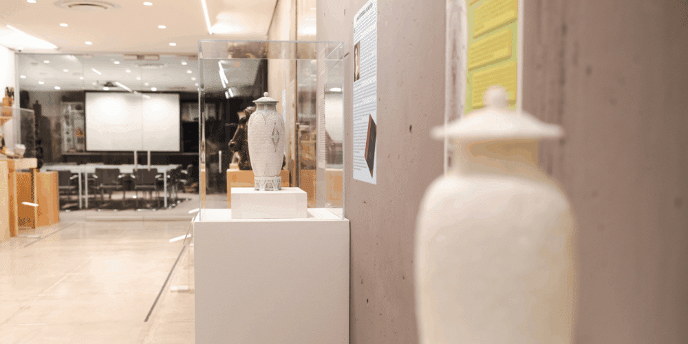 The 3D printed model sits next to the real "Scarab Vase" in the Everson's Ceramics Gallery