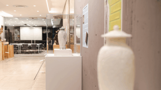 The 3D printed model sits next to the real "Scarab Vase" in the Everson's Ceramics Gallery